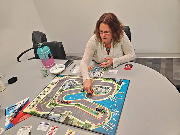 Photo of woman playing a board game.
